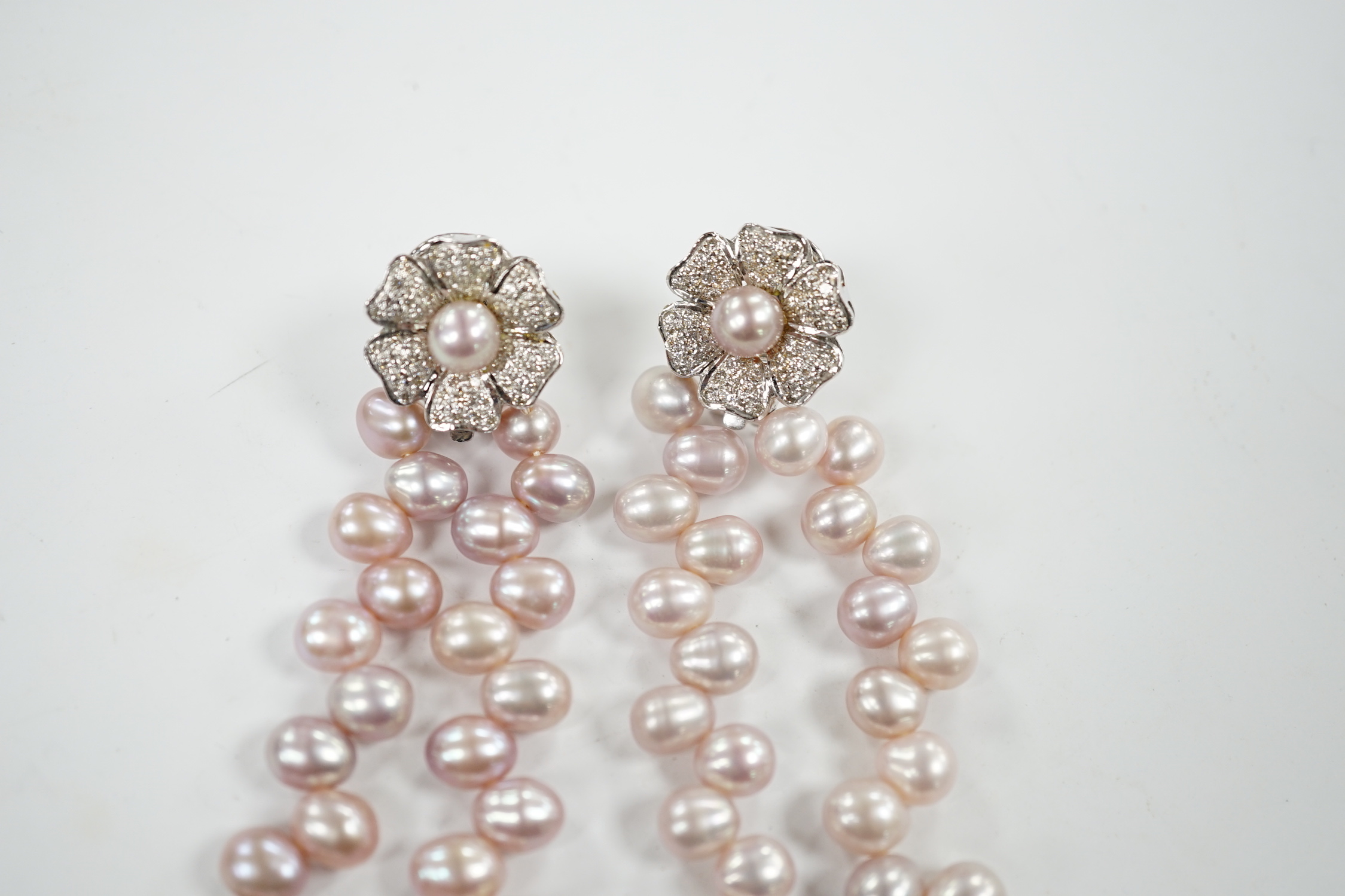 A modern pair of white metal, diamond chip cluster and three row pink cultured pearl tassel drop earrings, 91mm.